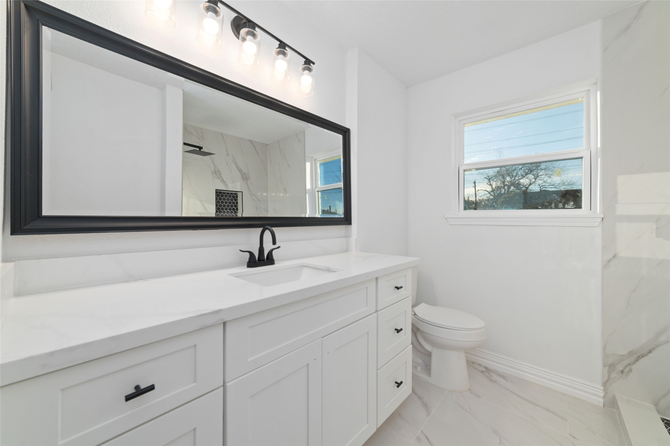 11434 Sharpview Drive Houston, TX 77072 - Photo 19 of 25 a bathroom with a toilet sink and mirror