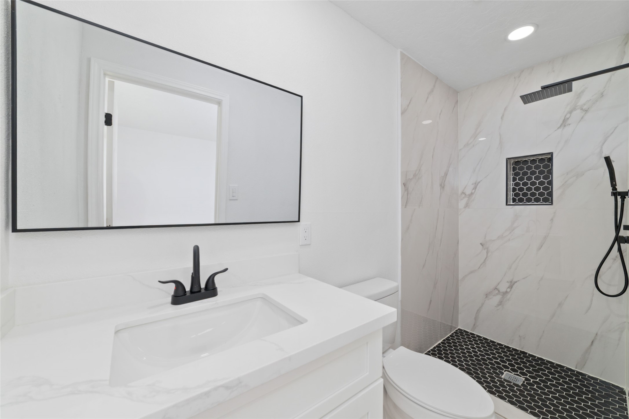 11434 Sharpview Drive Houston, TX 77072 - Photo 23 of 25 a bathroom with a sink a toilet and a shower