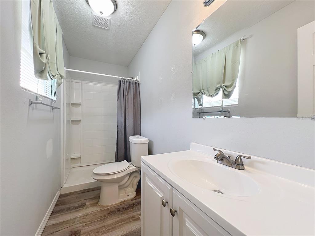 1109 5th Street Southwest Winter Haven, FL 33880 - Photo 12 of 20 a bathroom with a sink toilet and shower