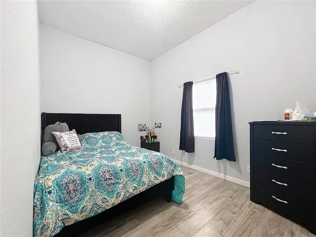 a bedroom with a bed and a dresser