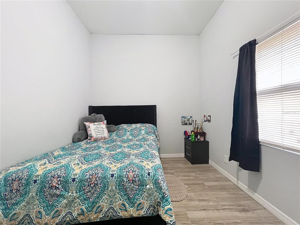 1109 5th Street Southwest Winter Haven, FL 33880 - Photo 17 of 20 a bedroom with a bed and window