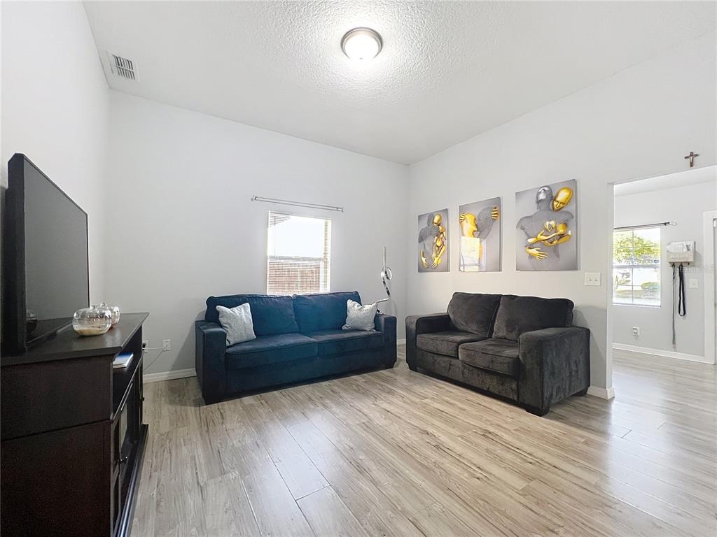 1109 5th Street Southwest Winter Haven, FL 33880 - Photo 5 of 20 a living room with furniture and a flat screen tv