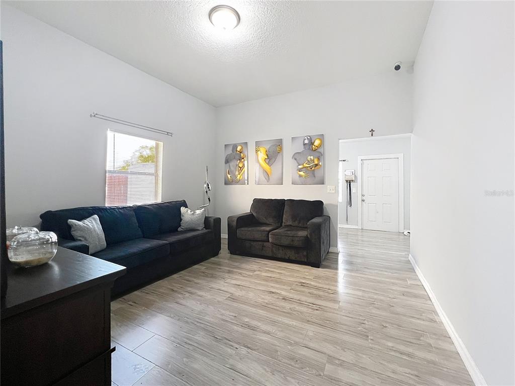 1109 5th Street Southwest Winter Haven, FL 33880 - Photo 6 of 20 a living room with furniture and a wooden floor