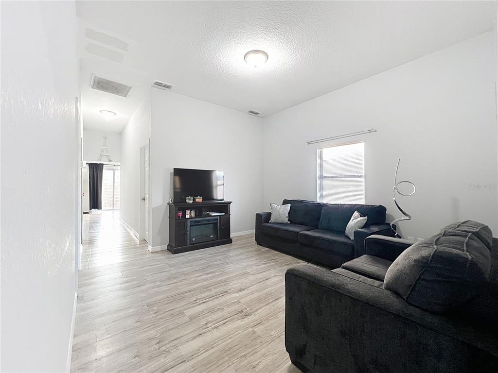 1109 5th Street Southwest Winter Haven, FL 33880 - Photo 7 of 20 a living room with furniture and a flat screen tv