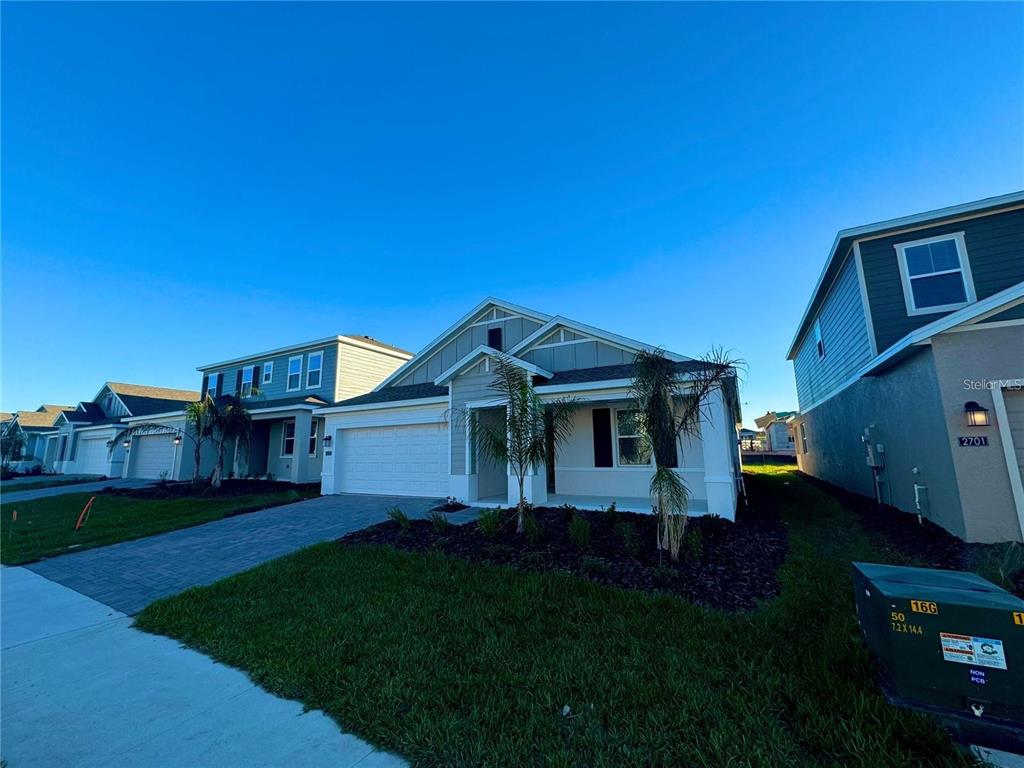 2693 Armstrong Avenue, Unit B Clermont, FL 34714 - Photo 3 of 10 a front view of a house with a garden and yard