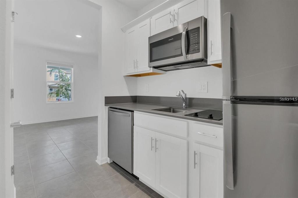 2693 Armstrong Avenue, Unit B Clermont, FL 34714 - Photo 6 of 10 a kitchen with stainless steel appliances granite countertop a sink and a microwave