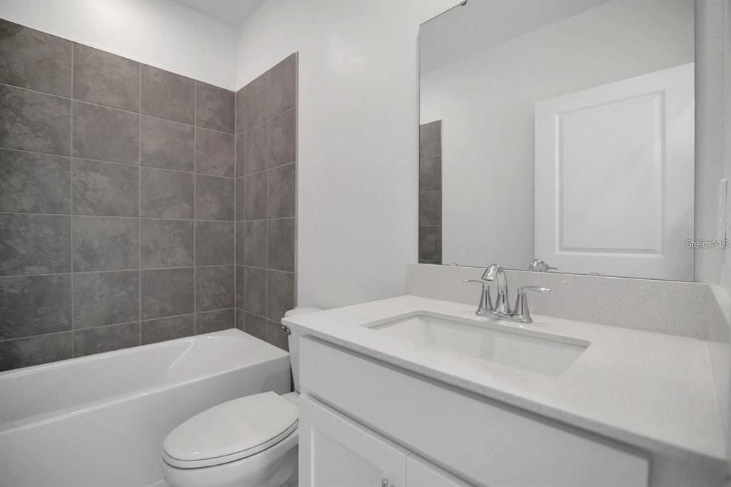 2693 Armstrong Avenue, Unit B Clermont, FL 34714 - Photo 8 of 10 a bathroom with a sink a toilet and bathtub