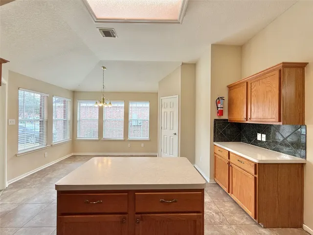 a room with pool table and window