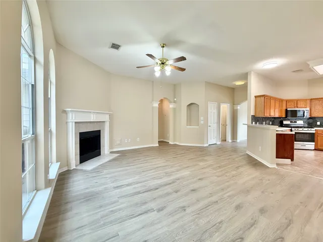 a view of a kitchen with a sink and a fireplace