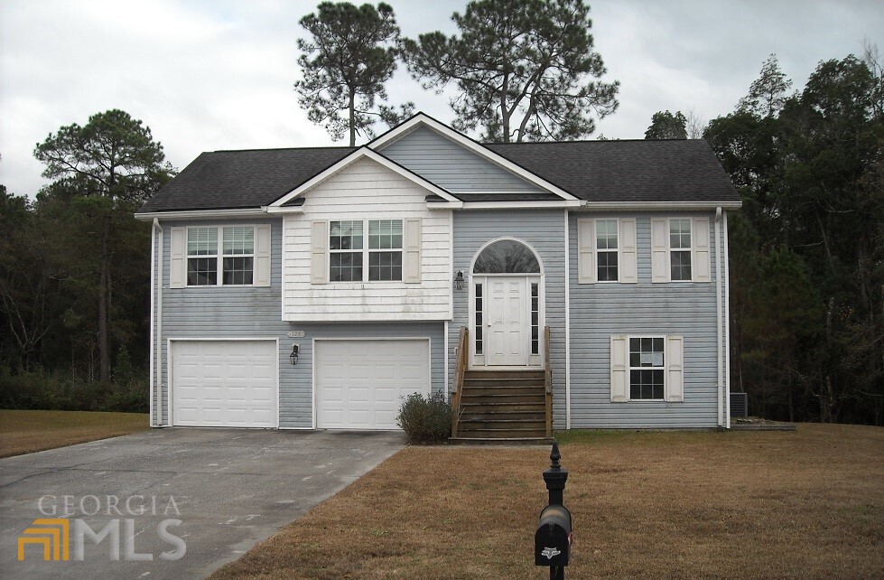 124 Ridgewood Circle Rincon, GA 31326 - Photo 1 of 1 a front view of a house with a yard