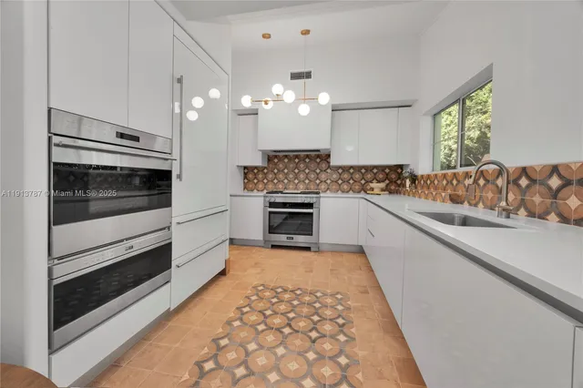 a kitchen with a sink stove and microwave