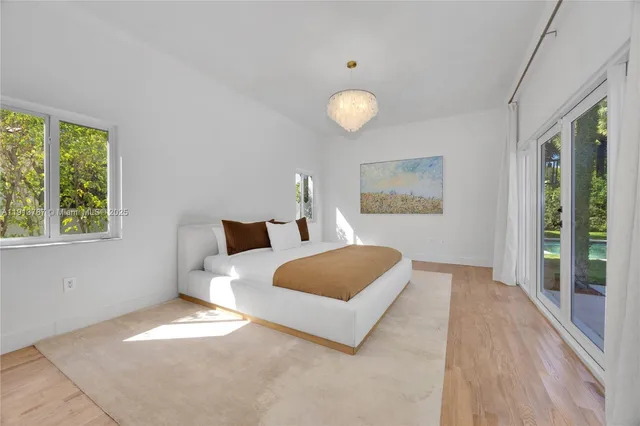 a bedroom with a large bed and a large window