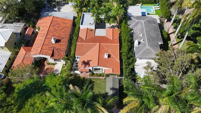 an aerial view of multiple houses with yard