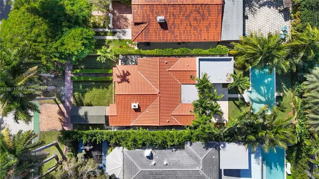 an aerial view of a house with a yard and garden