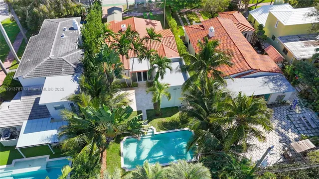 an aerial view of residential house with outdoor space and swimming pool