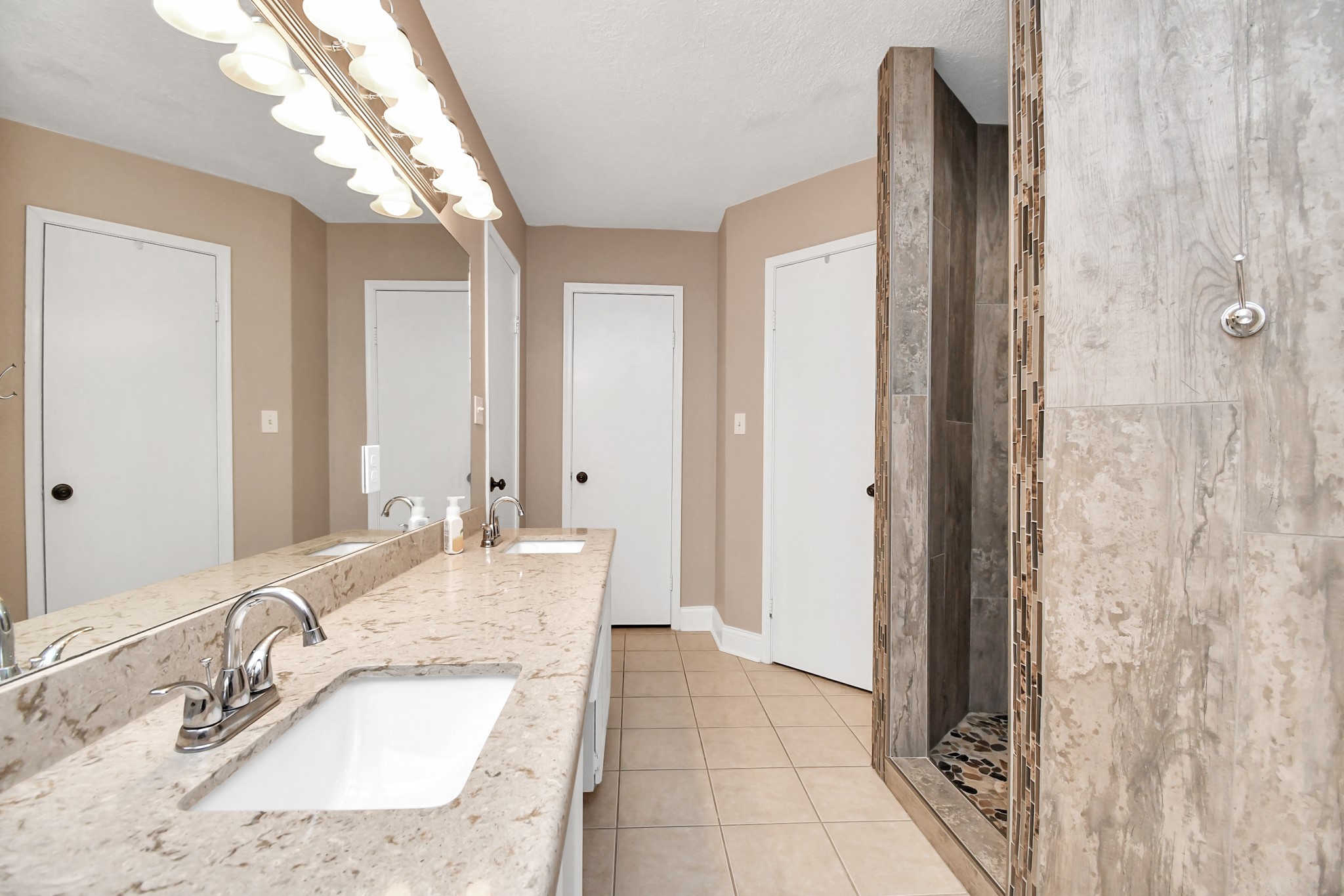 20202 Deer Run Road Damon, TX 77430 - Photo 16 of 45 a bathroom with a granite countertop sink and a mirror