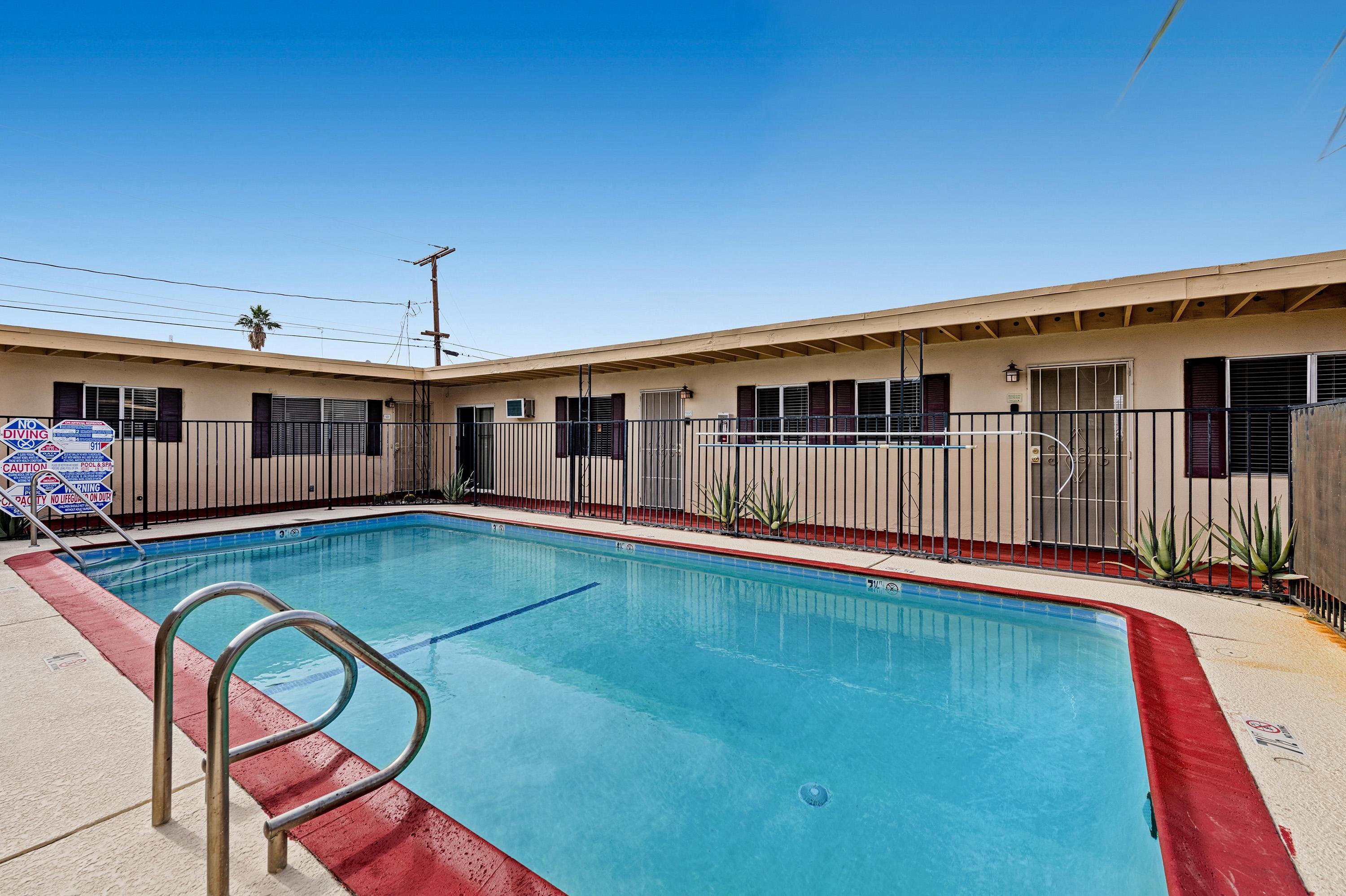 66665 First Street Desert Hot Springs, CA 92240 - Photo 17 of 35 a view of a house with swimming pool in front of it