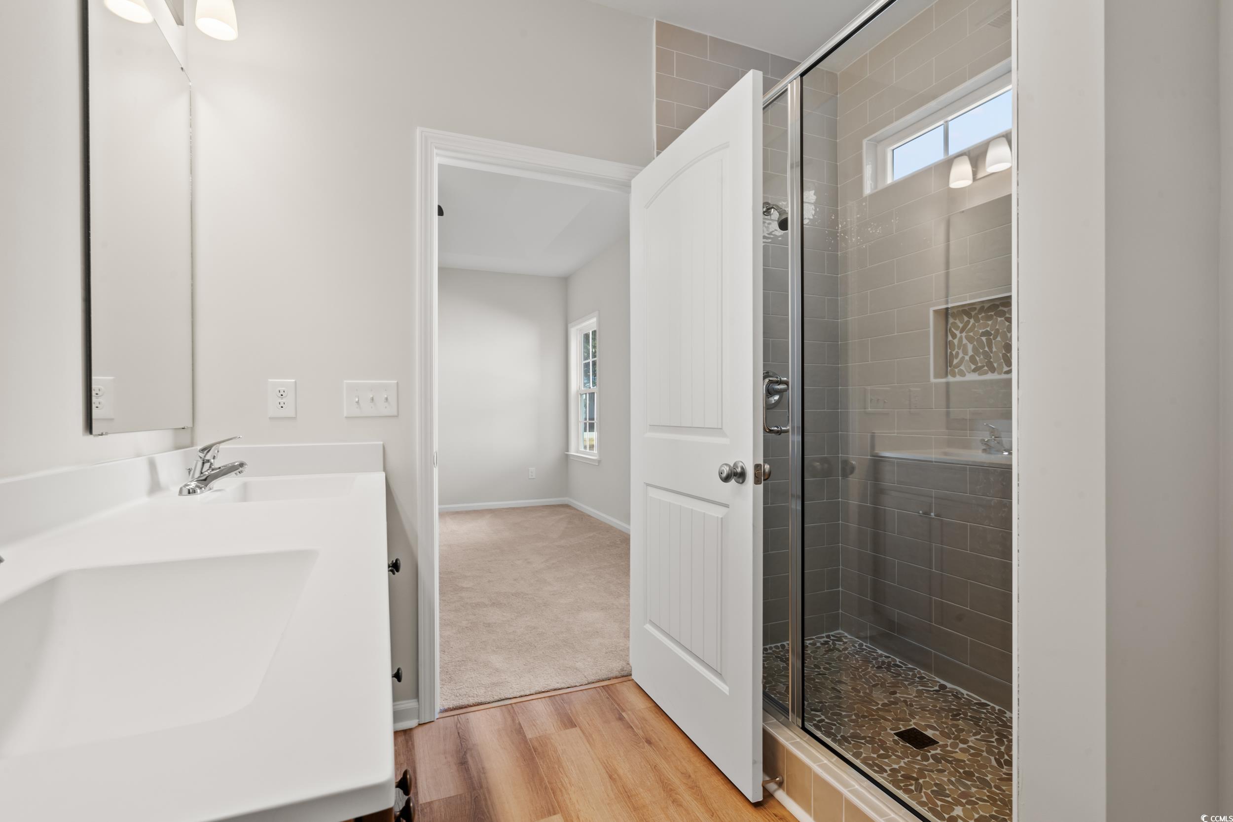 2315 Withers Street Georgetown, SC 29440 - Photo 11 of 29 Full bathroom featuring double vanity, a stall shower, and light wood-type flooring