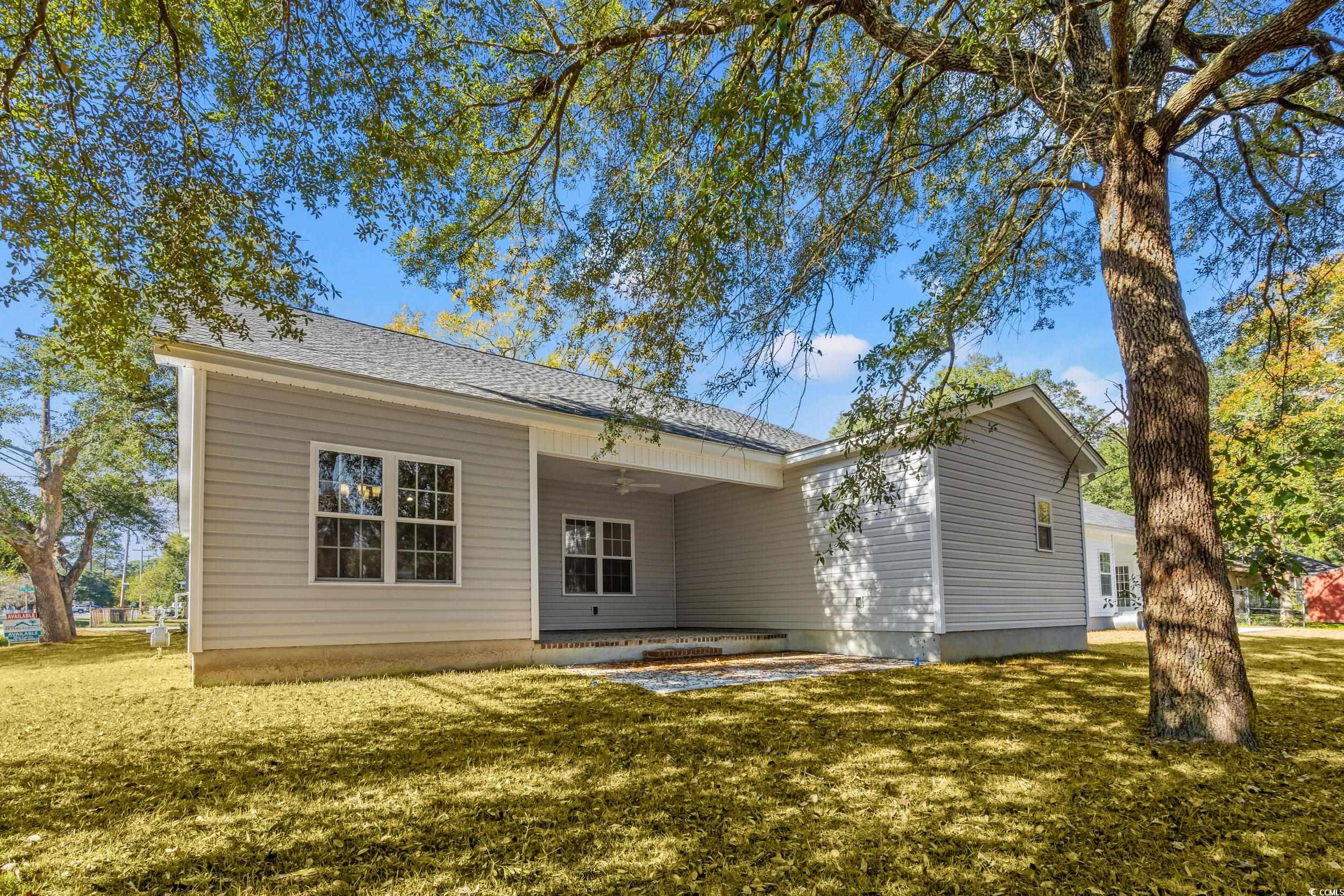 2315 Withers Street Georgetown, SC 29440 - Photo 18 of 29 Back of property featuring a patio area, ceiling fan, a yard, and a shingled roof