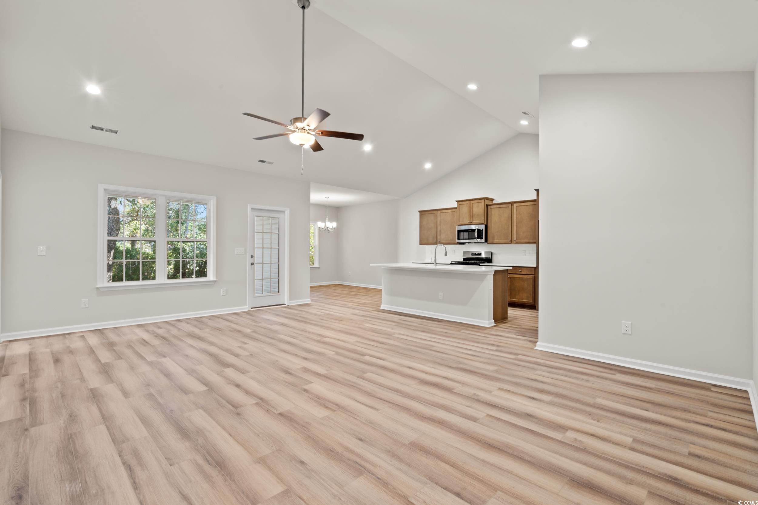 2315 Withers Street Georgetown, SC 29440 - Photo 2 of 29 Unfurnished living room with a ceiling fan, light wood-style flooring, a chandelier, recessed lighting, and high vaulted ceiling