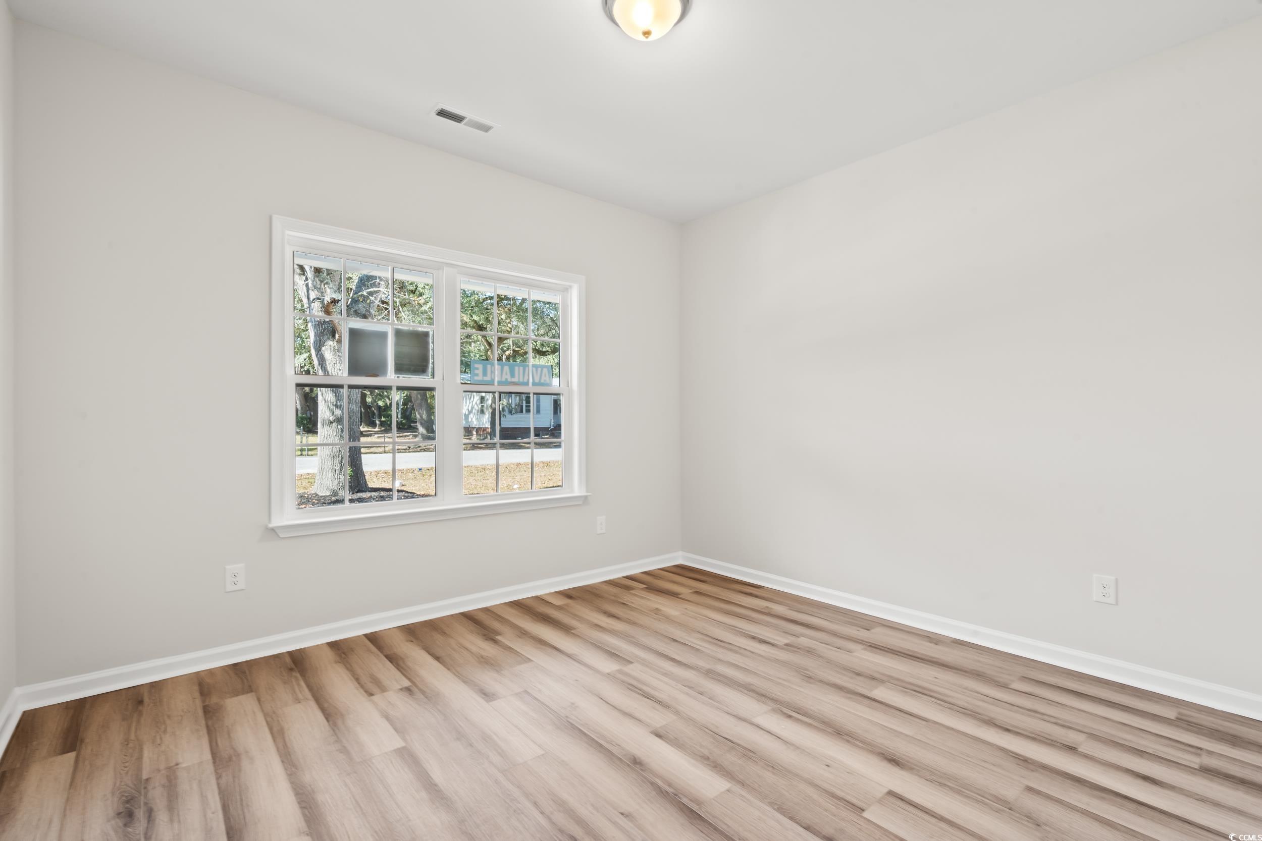 2315 Withers Street Georgetown, SC 29440 - Photo 6 of 29 Spare room featuring light wood-style floors and baseboards