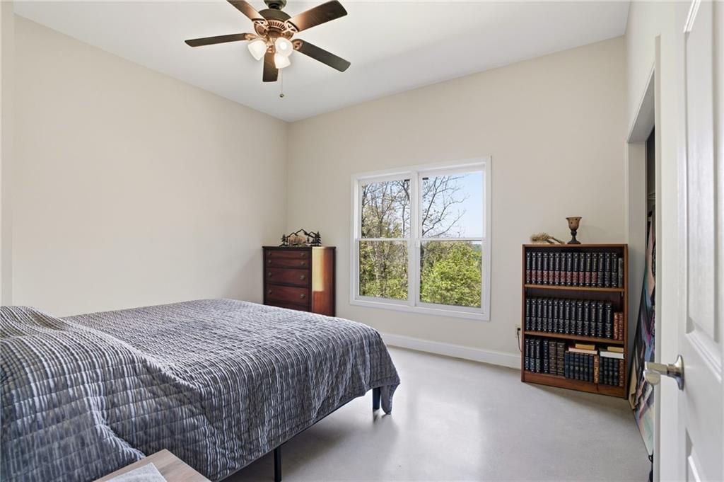 3326 Monument Road Jasper, GA 30143 - Photo 29 of 49 a bedroom with a bed and a chandelier