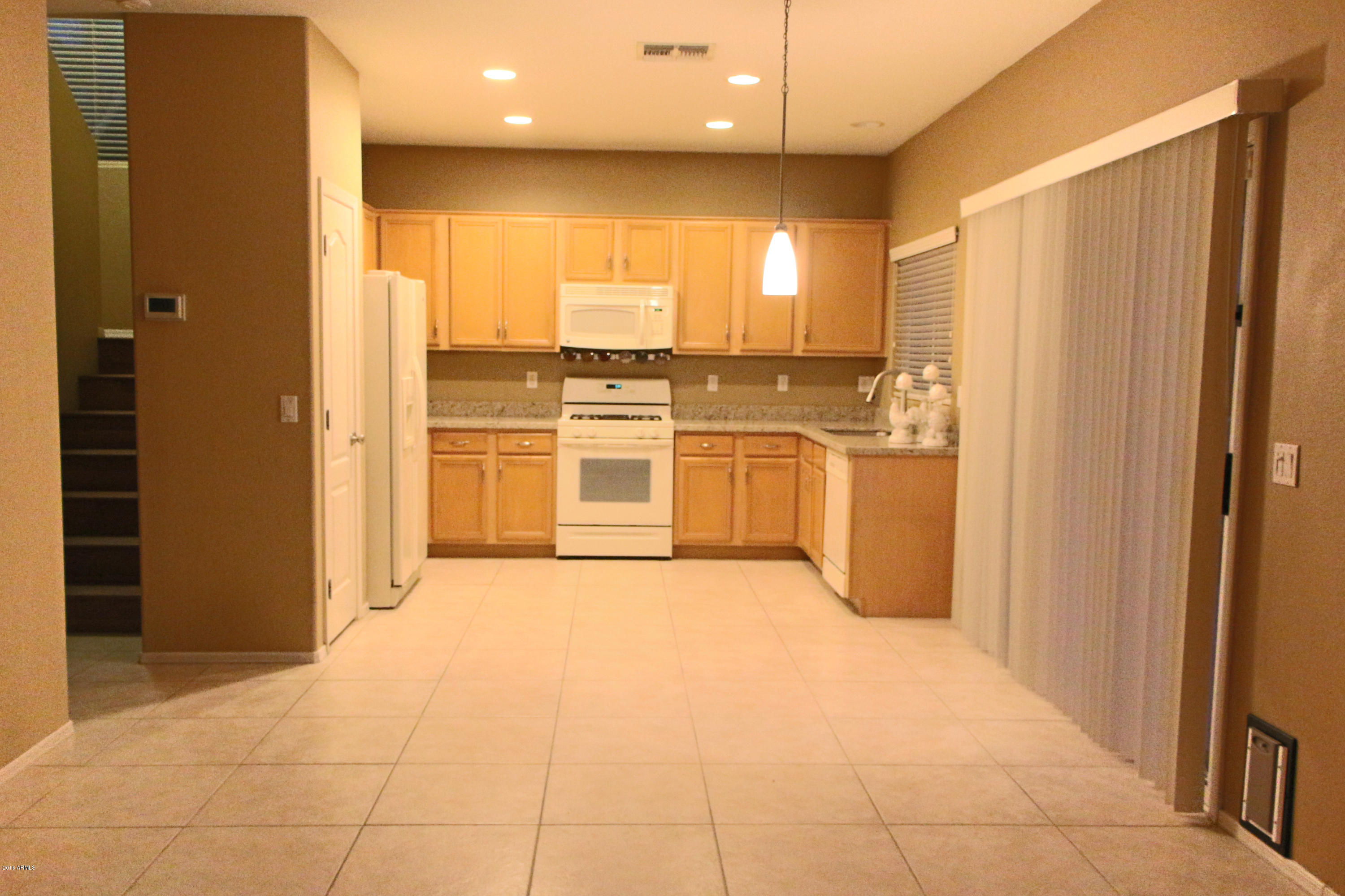 3517 South Sawmill Road Gilbert, AZ 85297 - Photo 11 of 26 a view of a kitchen with a sink and a refrigerator