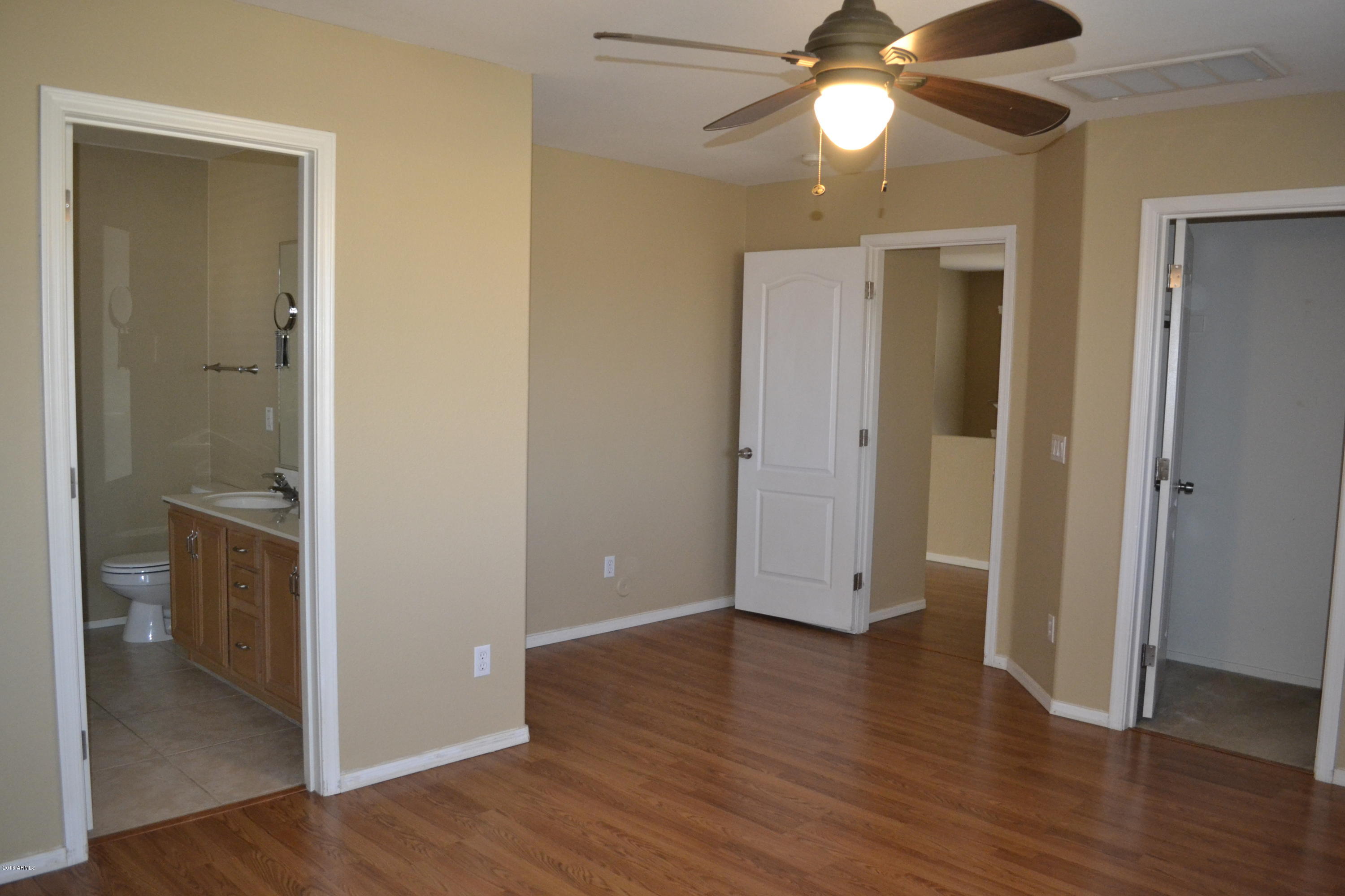 3517 South Sawmill Road Gilbert, AZ 85297 - Photo 15 of 26 an empty room with wooden floor and a ceiling fan