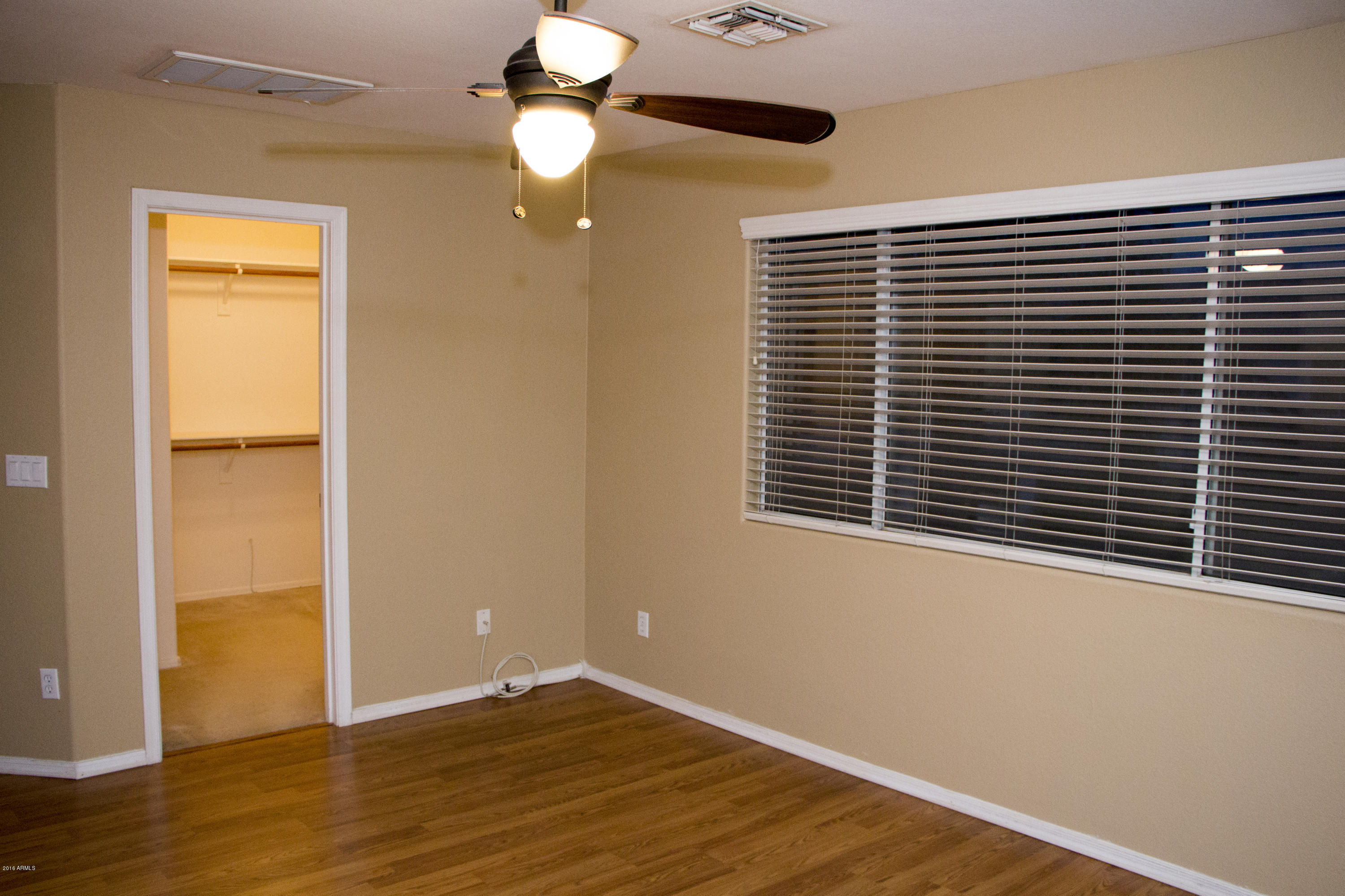 3517 South Sawmill Road Gilbert, AZ 85297 - Photo 16 of 26 a view of an empty room with wooden floor and a window