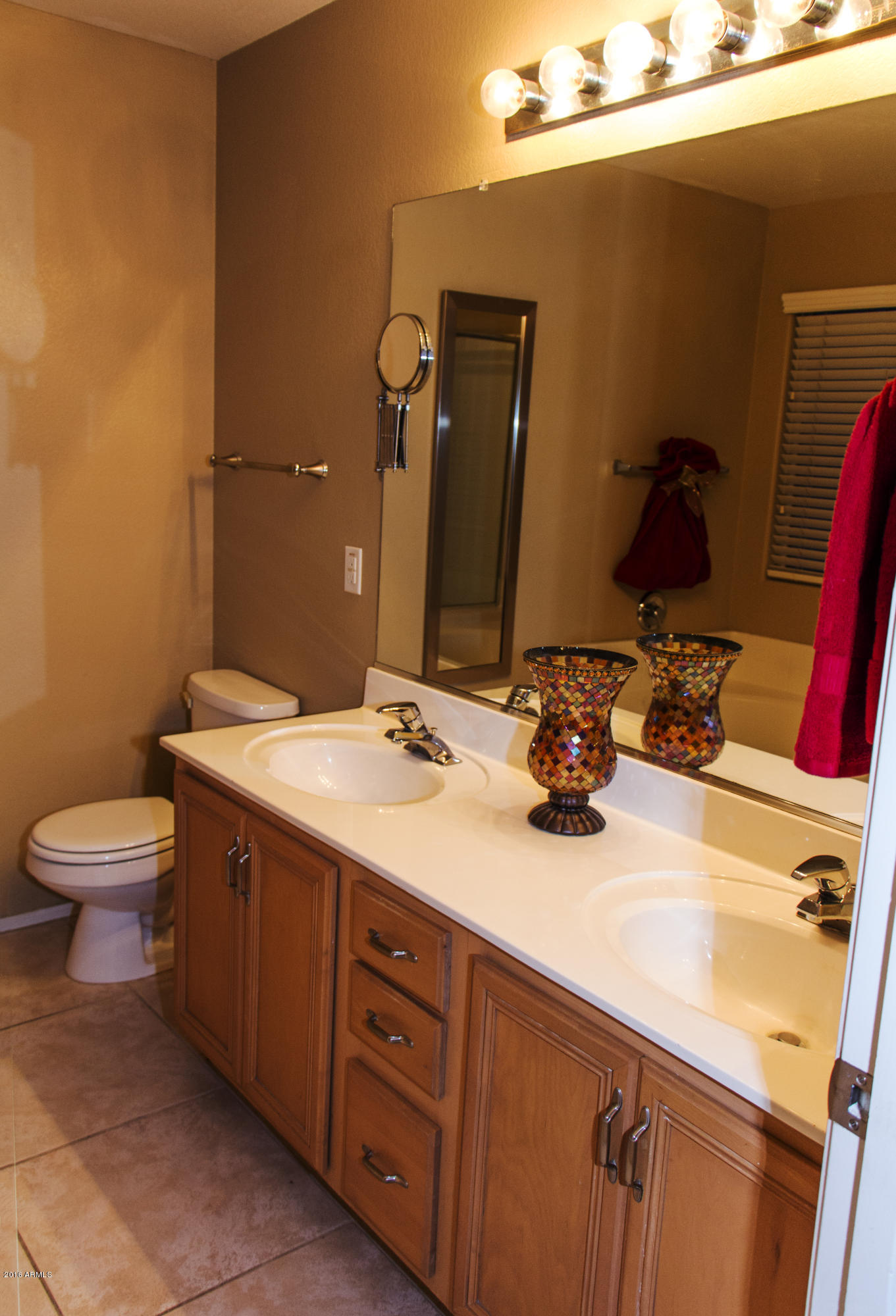 3517 South Sawmill Road Gilbert, AZ 85297 - Photo 18 of 26 a bathroom with a double vanity sink toilet and a mirror