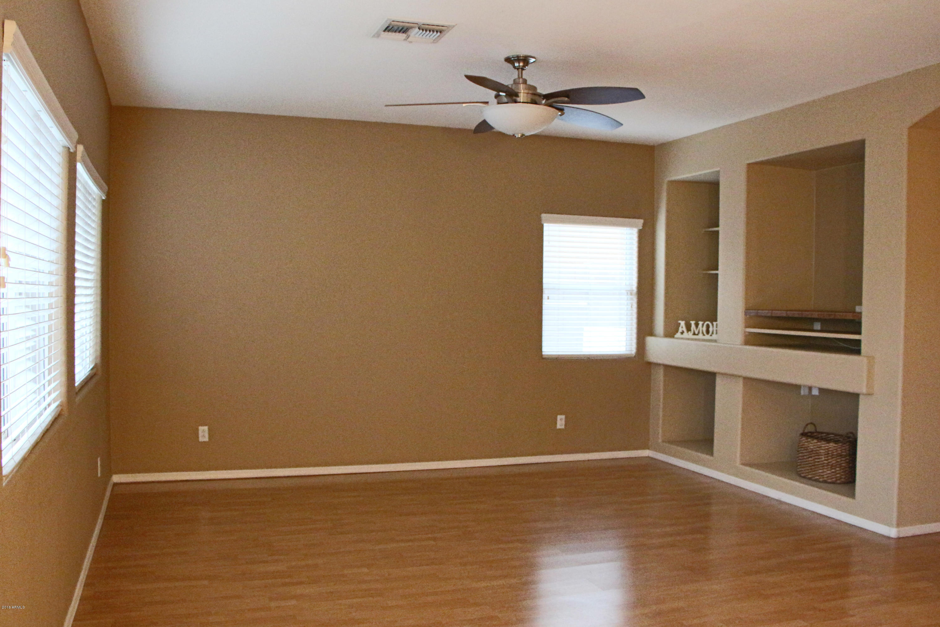 3517 South Sawmill Road Gilbert, AZ 85297 - Photo 10 of 26 a view of an empty room with a window and wooden floor