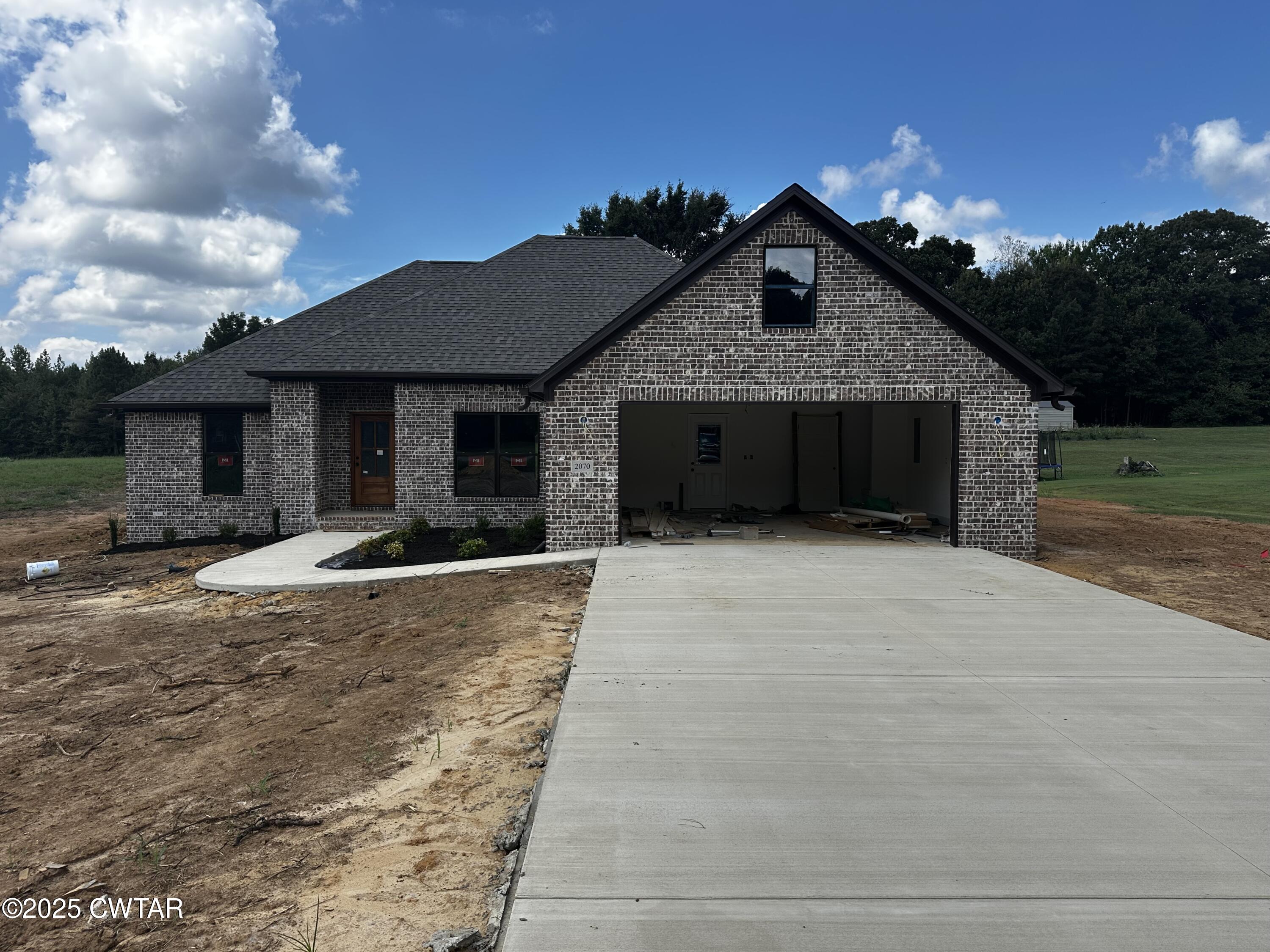 2070 Talley Store Road Henderson, TN 38340 - Photo 1 of 13 a front view of a house with a yard