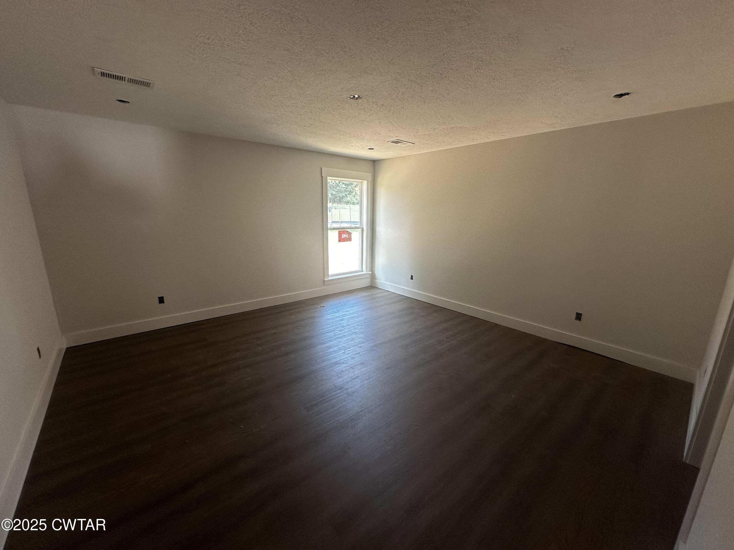 2070 Talley Store Road Henderson, TN 38340 - Photo 8 of 13 an empty room with wooden floor and windows