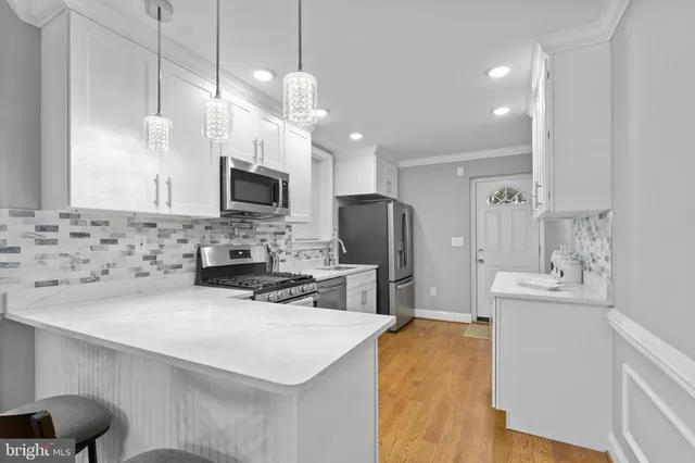 a kitchen with stainless steel appliances a stove sink and microwave