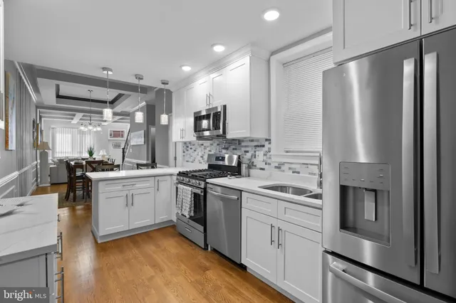 a kitchen with stainless steel appliances a refrigerator sink and microwave