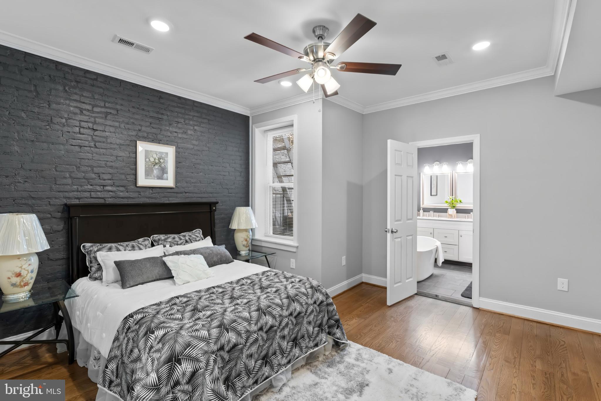 1330 Aisquith Street Baltimore, MD 21202 - Photo 17 of 47 a bedroom with a large bed and a chandelier