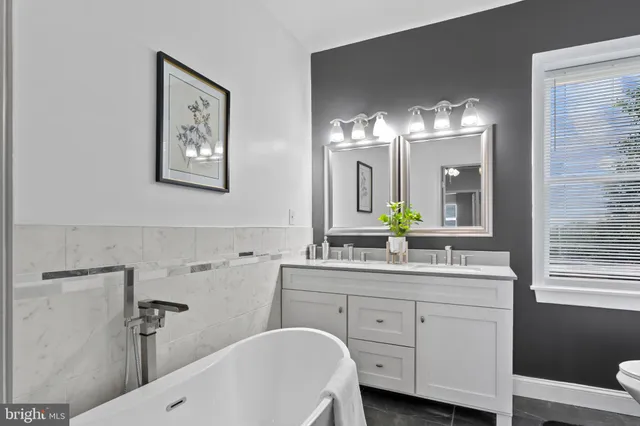 a bathroom with a double vanity sink and a mirror