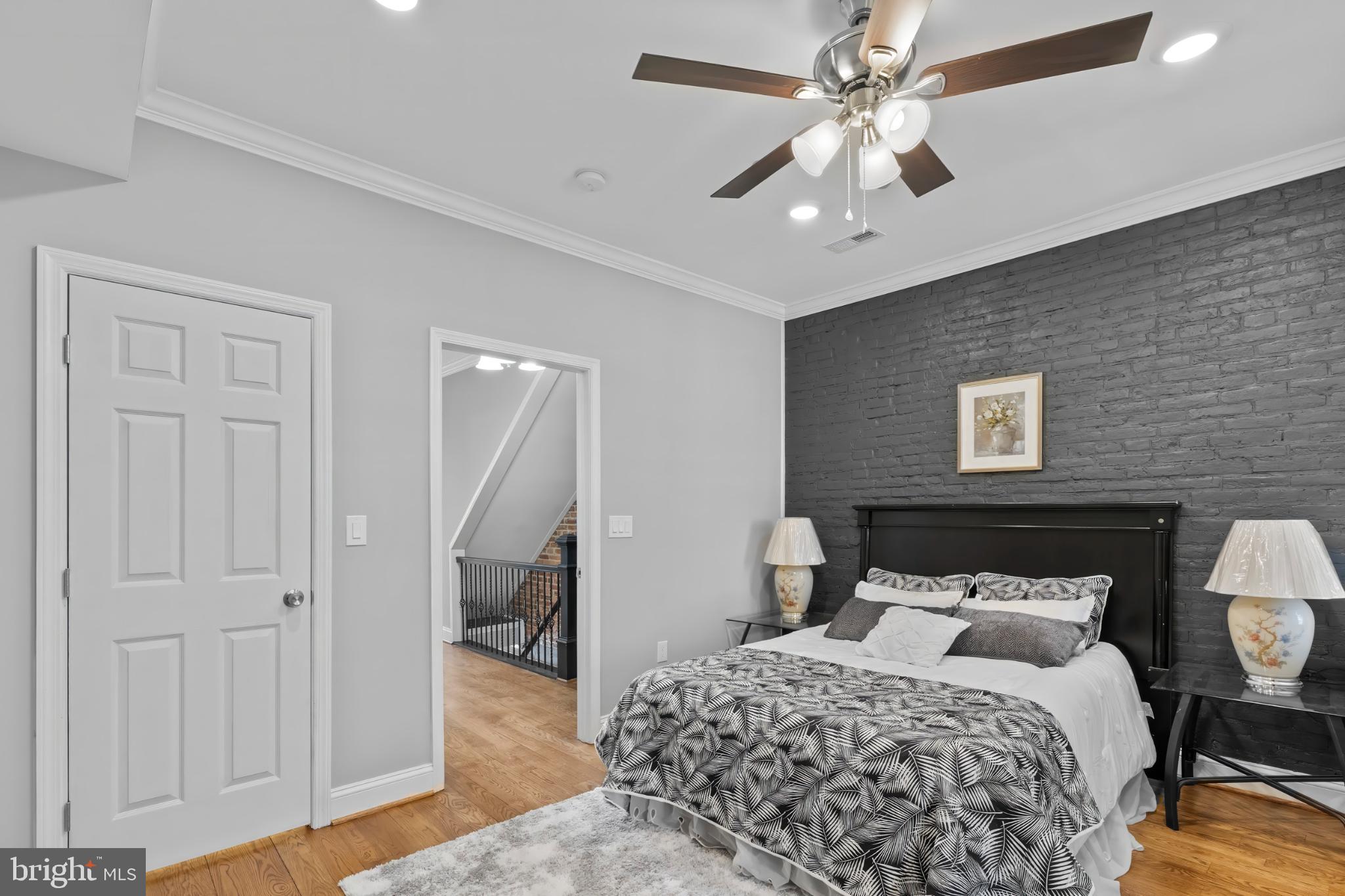 1330 Aisquith Street Baltimore, MD 21202 - Photo 23 of 47 a bedroom with a bed and a chandelier