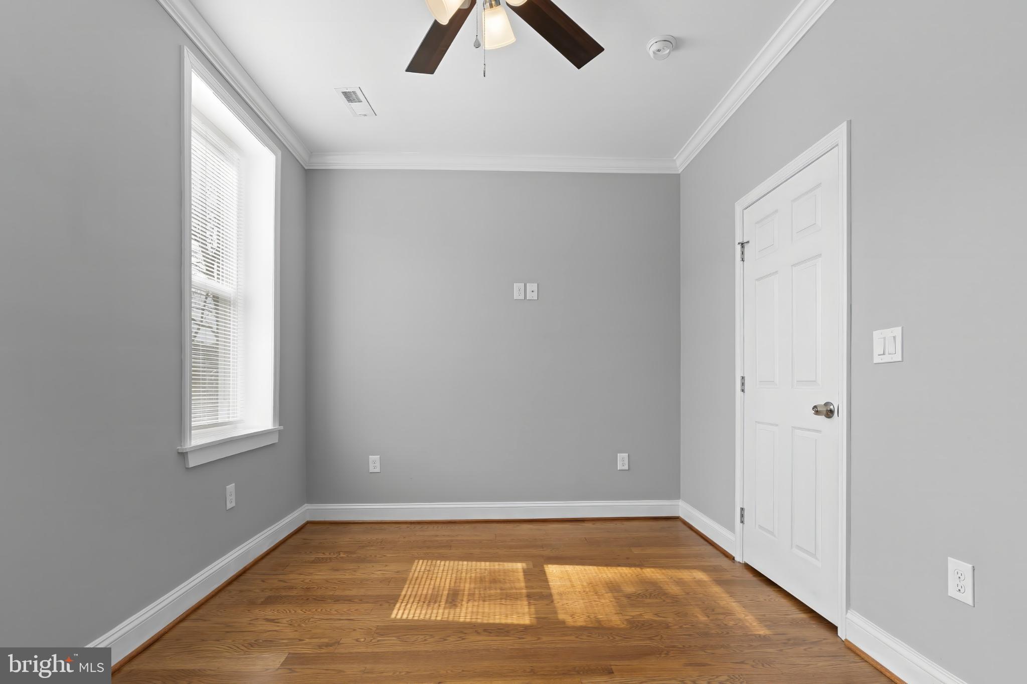 1330 Aisquith Street Baltimore, MD 21202 - Photo 25 of 47 a view of an empty room with window and wooden floor