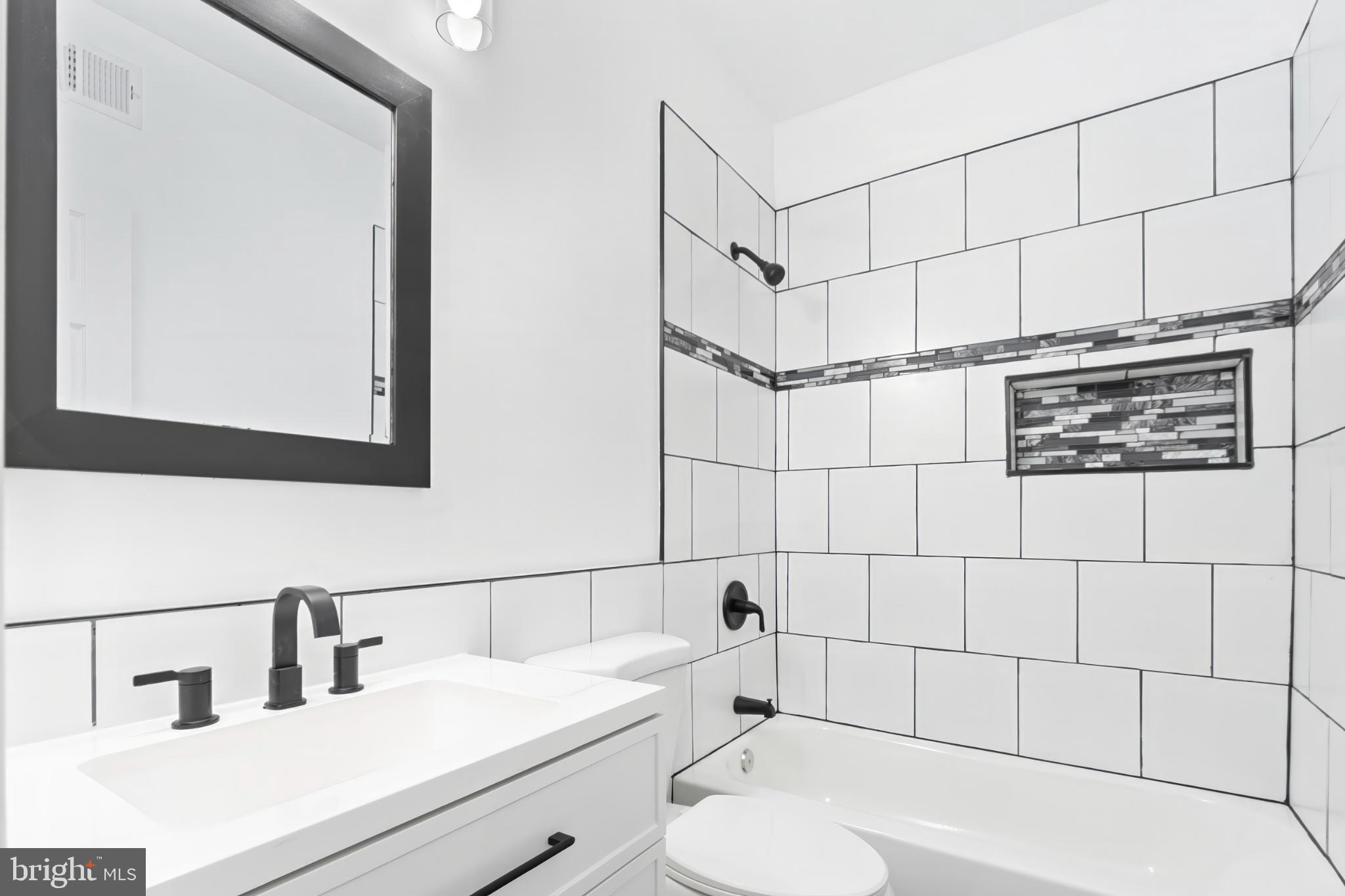 1330 Aisquith Street Baltimore, MD 21202 - Photo 30 of 47 a bathroom with a sink and mirror