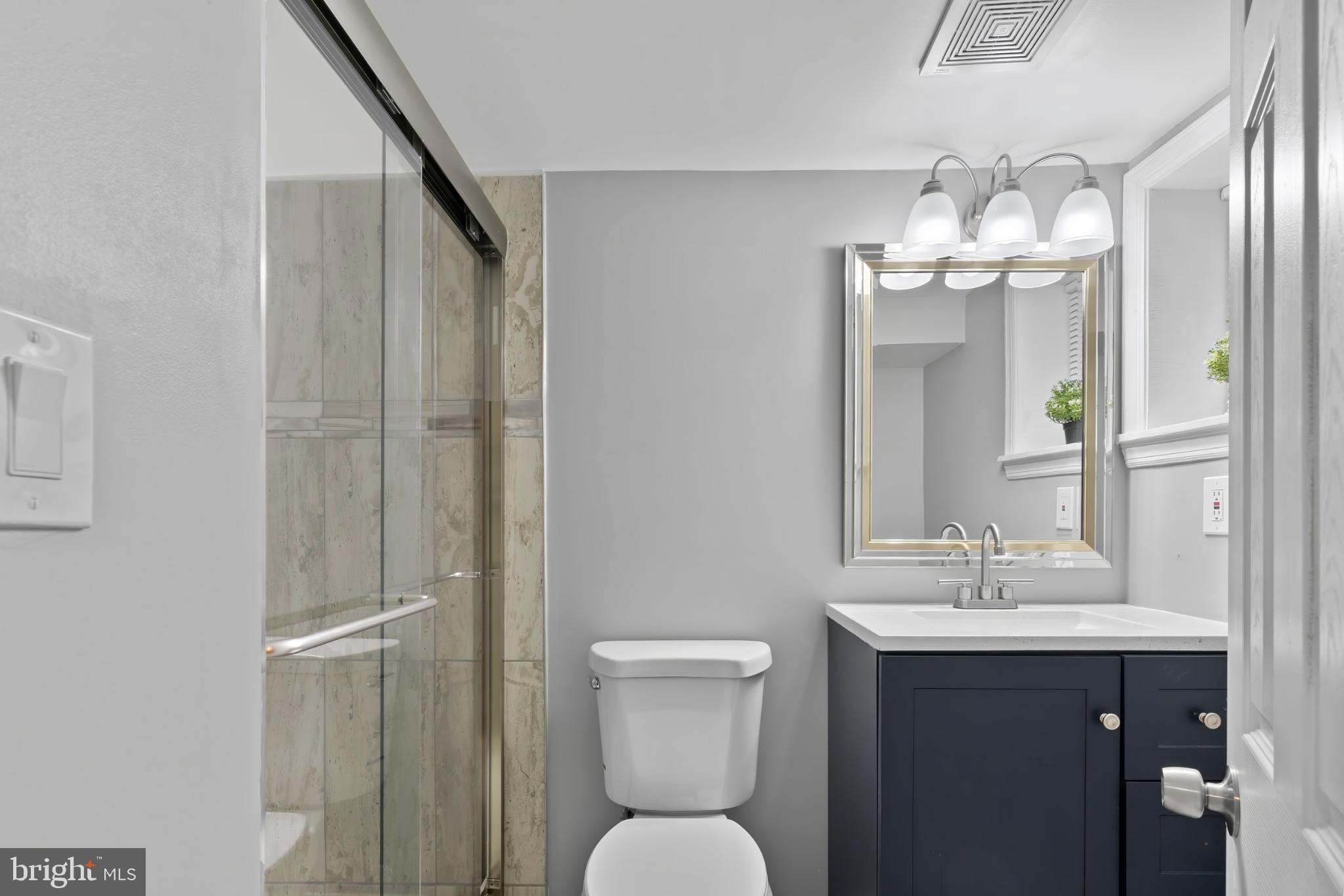 1330 Aisquith Street Baltimore, MD 21202 - Photo 35 of 47 a bathroom with a sink and a mirror