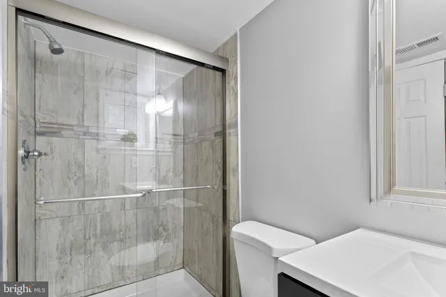 a bathroom with a shower and a sink