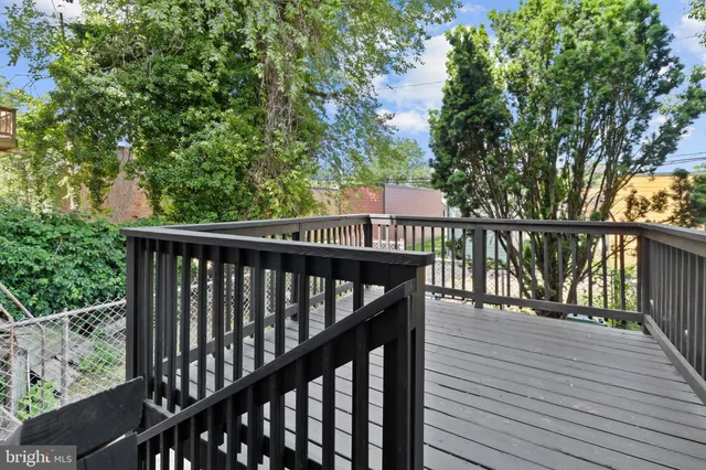 a view of balcony with wooden floor and fence