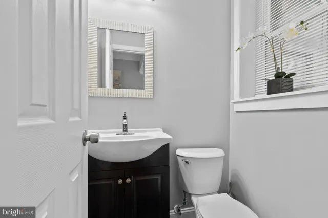 a bathroom with a sink toilet and mirror