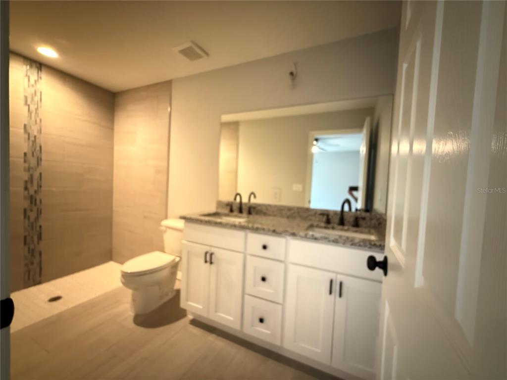 20500 Southwest 54th Street Dunnellon, FL 34431 - Photo 26 of 27 a spacious bathroom with a granite countertop sink mirror and a toilet
