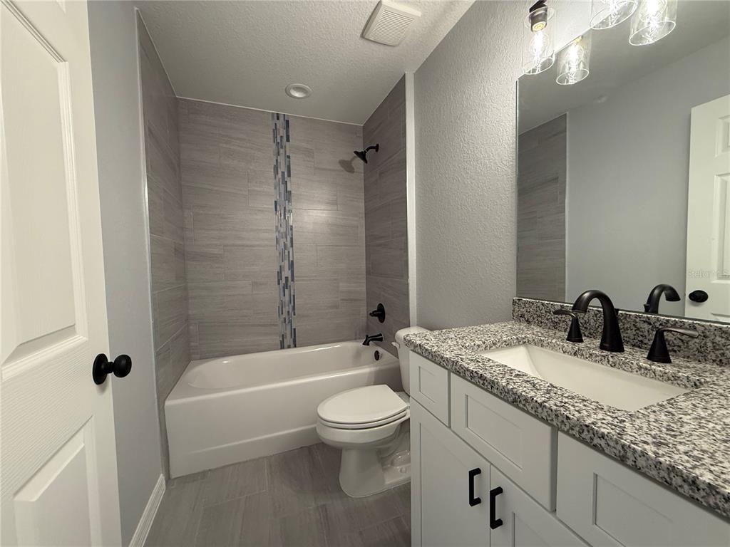 20500 Southwest 54th Street Dunnellon, FL 34431 - Photo 5 of 27 a bathroom with a granite countertop sink toilet tub and shower