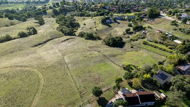 a view of a field with a building in the background