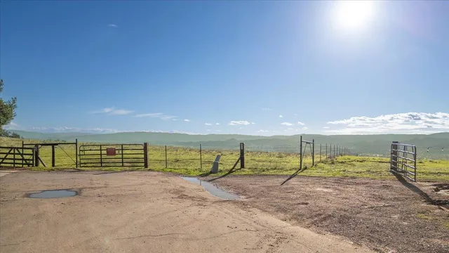 a view of a park with slides and a wooden deck