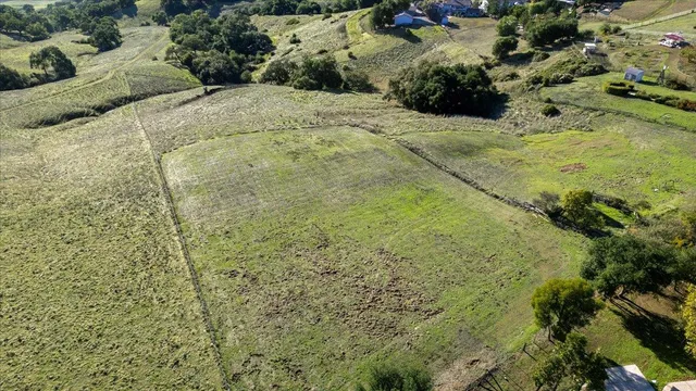 an aerial view of residential houses with outdoor space and street view