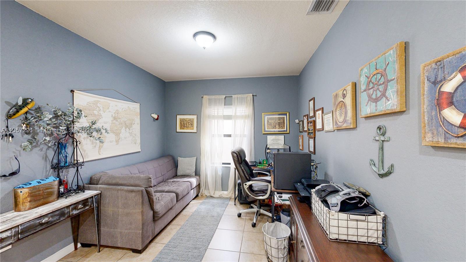 672 Southeast 34th Avenue Homestead, FL 33033 - Photo 13 of 65 a living room with furniture and a window